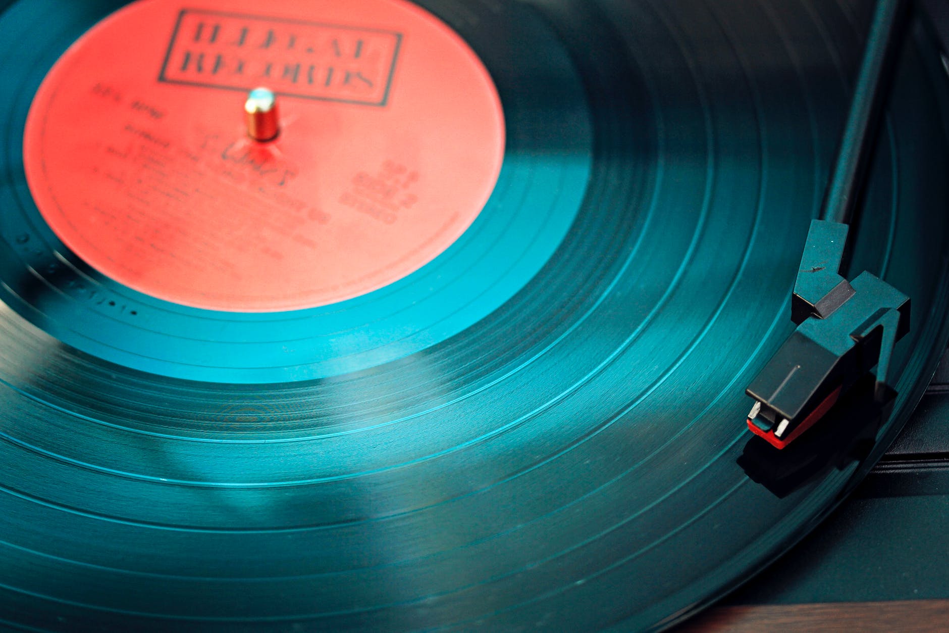 black vinyl record playing on turntable