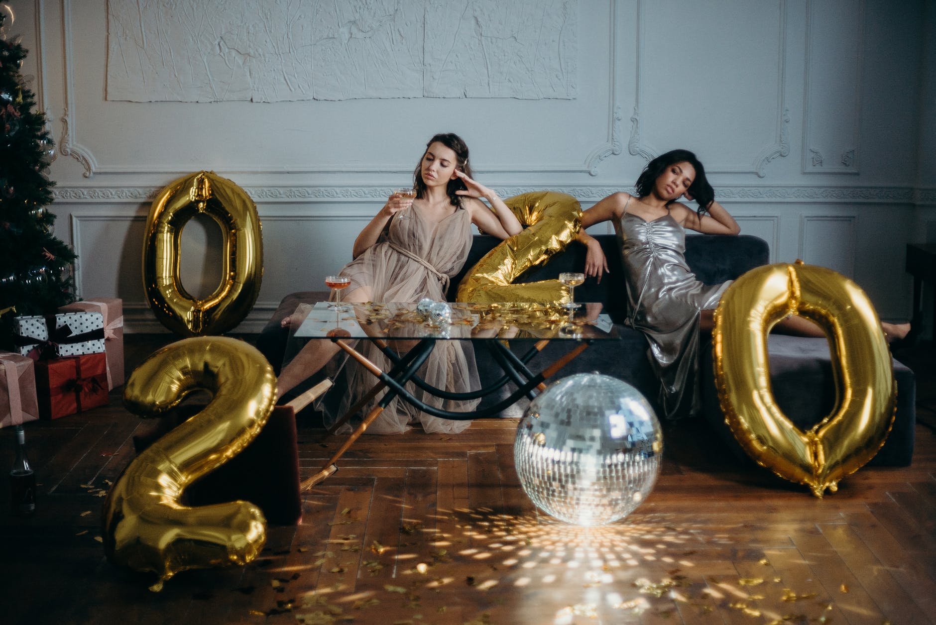 photo of women sitting on couch